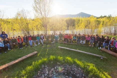The volunteers around the fire place in the field camp «Ermak»