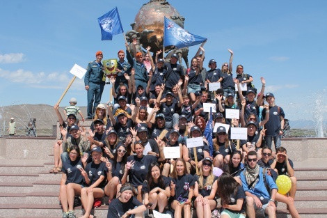 The volunteers of the expedition against the background «Center of Asia» in Kyzyl