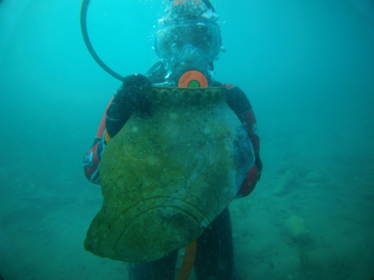Kristina Guseynova, a laboratory assistant at the Institute of Archaeology of the Russian Academy of Sciences, with a part of an ancient jug. Photo: Elizaveta Romashkina