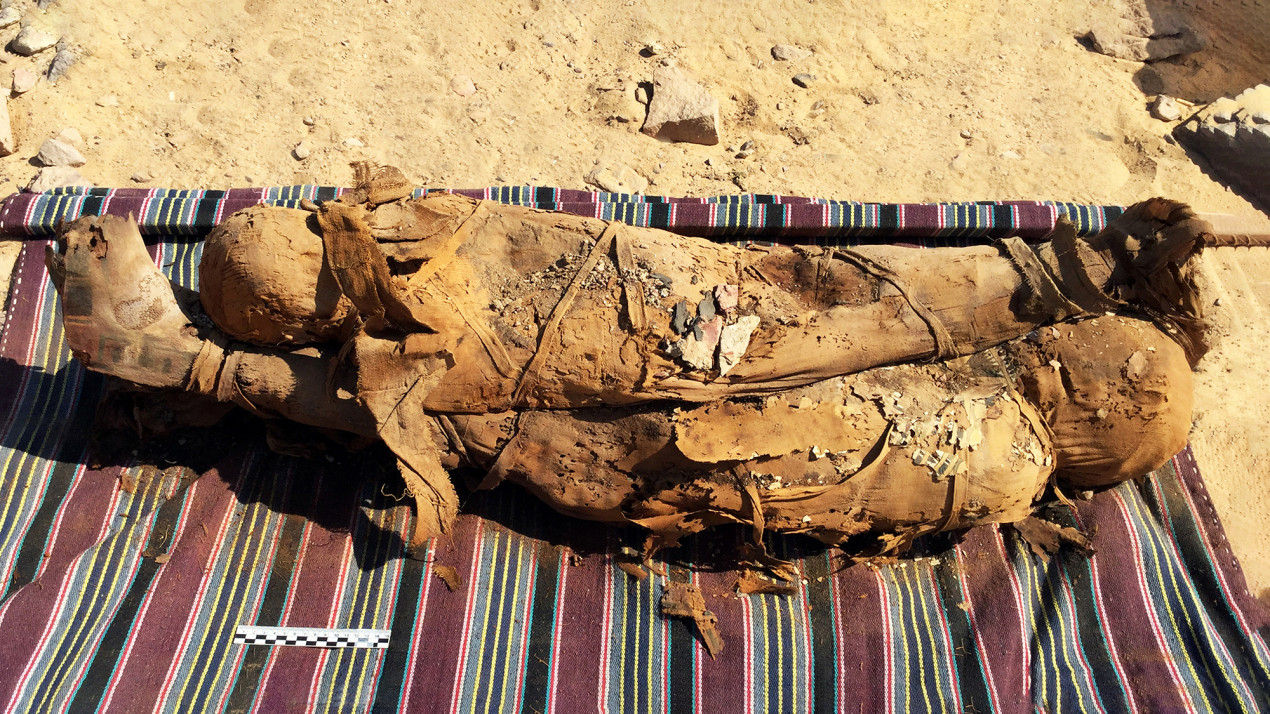 Mummified children (possibly brother and sister) laid over one another from the tomb AGH026. Photo:   @eimawa-unimi